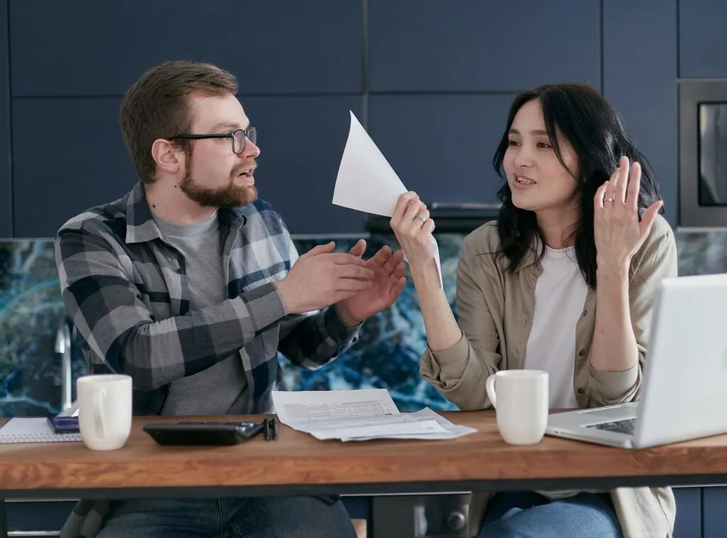 Couple discussing family finances and paperwork